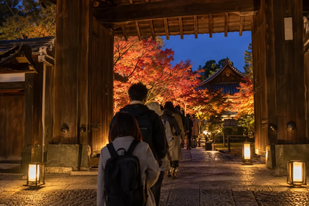 Visitors entering a separately ticketed Kyoto temple illumination after dark